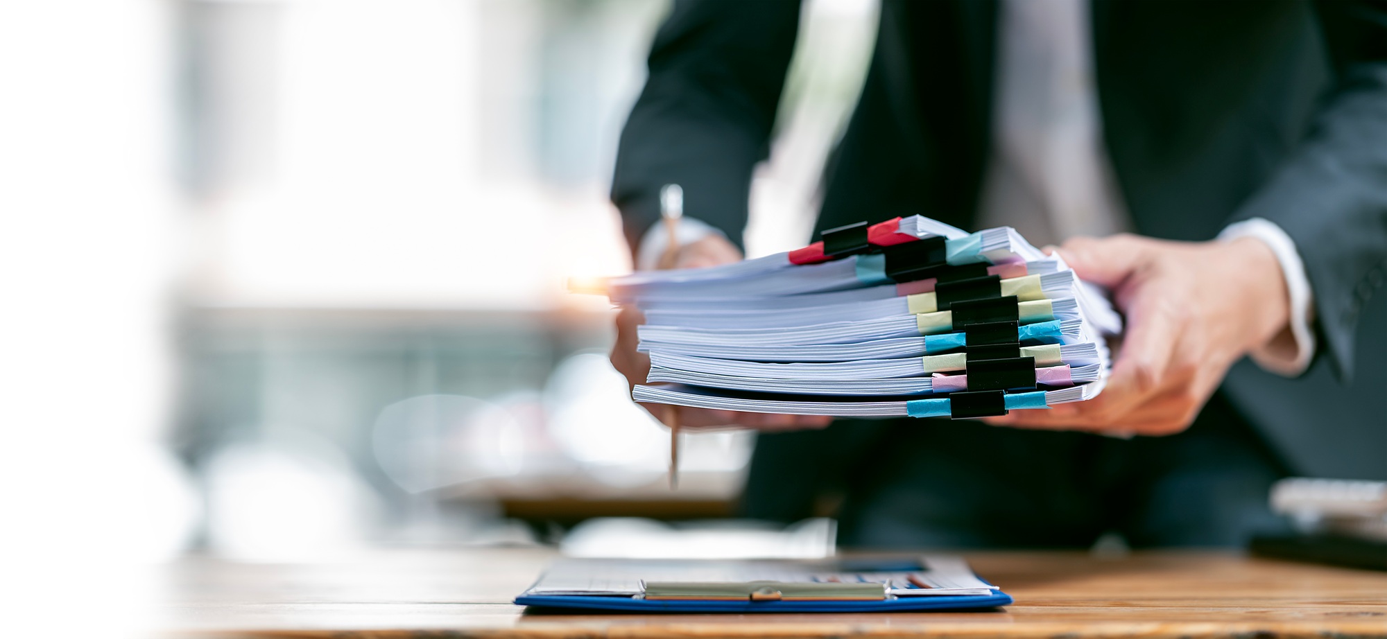 Businessman hands holding pile of paper or stack of document standing at desk office, copy space.