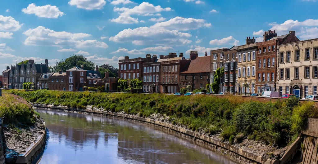 A view across the River Nene towards the North Brink in Wisbech, Cambridgeshire in the summertime